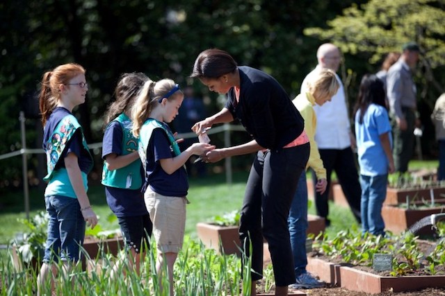 First Lady Michelle Obama joins students for the spring White House Kitchen Garden planting on the South Grounds, March 26, 2012. Participants include: Sam Kass, Senior Policy Advisor for Healthy Food Initiatives; and students from Stetson Elementary School in Chester, Pennsylvania; Kate Mitchell Elementary School in Ames, Iowa; Sumner Elementary School, Greensboro, North Carolina; Bancroft Elementary and Tubman Elementary Schools in Washington, D.C.; and Girl Scout Troop 60325 in Fairport, New York. (Official White House Photo by Sonya N. Hebert)